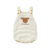 A cream-colored baby romper with a brown Santa face embroidery and Christmas text.