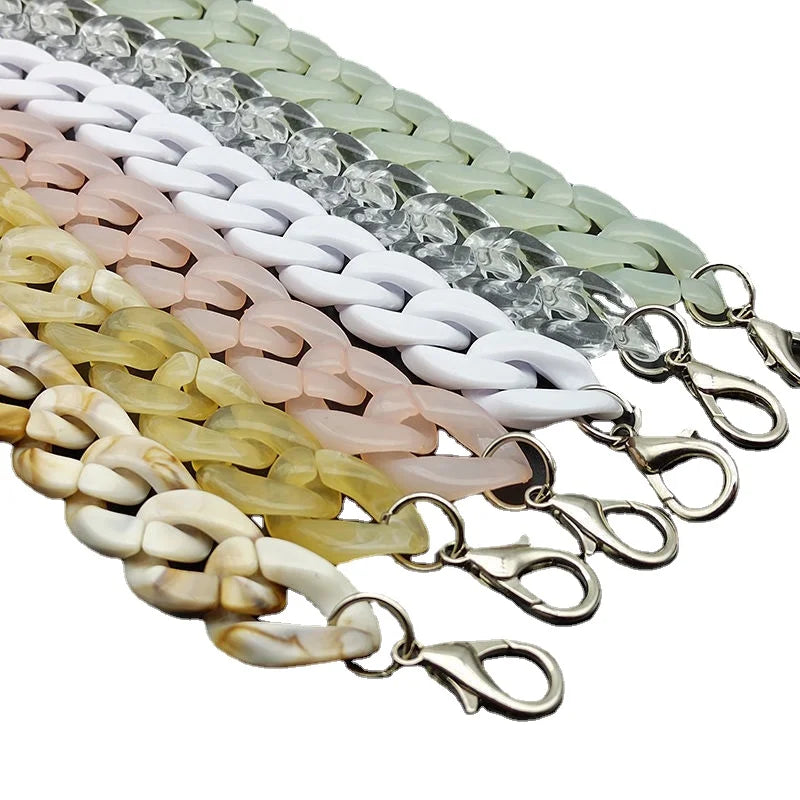 A close-up of multiple acrylic bag chain straps in various pastel colors, including white, pink, and green.