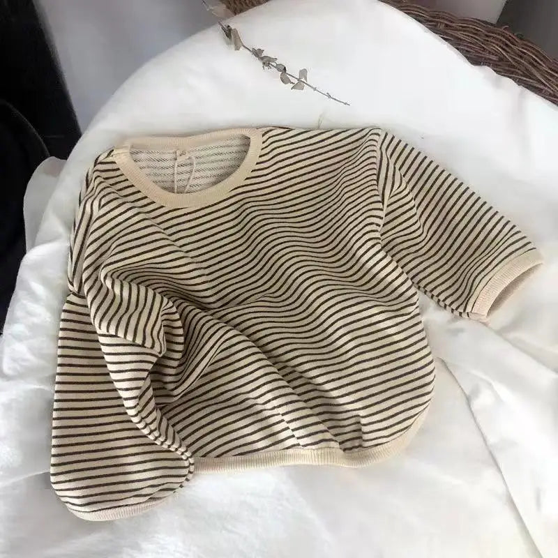 A beige and black striped kids cotton pullover sweatshirt laid flat on a white surface.