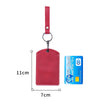 A red leather card holder attached to a keyring and a leather strap.