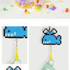 A collection of colorful plastic beads and a finished bead craft project featuring a blue bunny design.