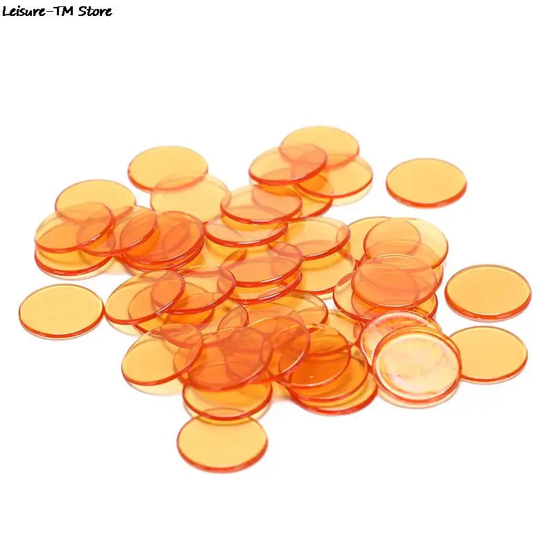 A collection of round, colorful plastic bingo chips in shades of orange and yellow.