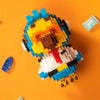 A Minecraft-style building block figure resembling a fiery animal with blue and yellow blocks on an orange background.