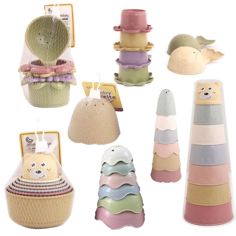 A set of boat-shaped stacking cups and bath toys for toddlers in various pastel colors.