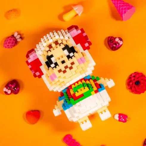A yellow and pink building block set featuring a character resembling a smiling animal face on an orange background.