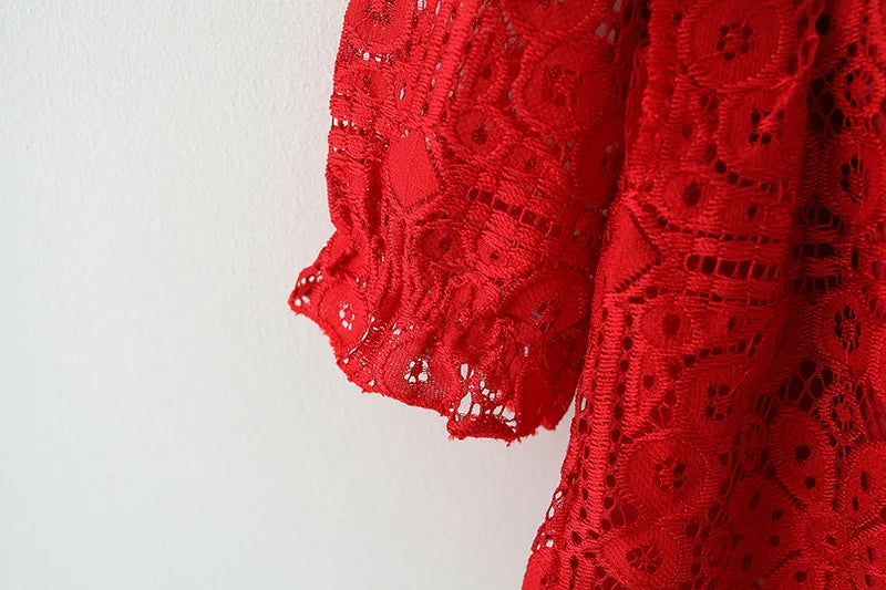 A close-up of a red lace princess dress with a doll collar, showing the intricate fabric detail.