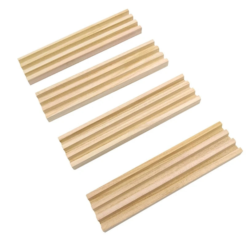 A set of four wooden domino racks used as premium tile holders for games.