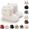 A collection of white and pink plush baby snow boots for girls and boys shown in various colors and styles.
