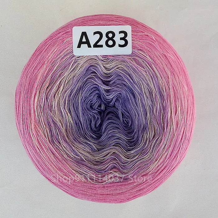 A ball of rainbow gradient mercerized cotton cake yarn labeled A283.