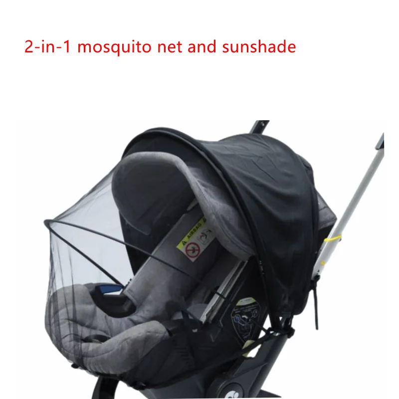 A black baby stroller with a transparent mosquito net and sunshade attached.