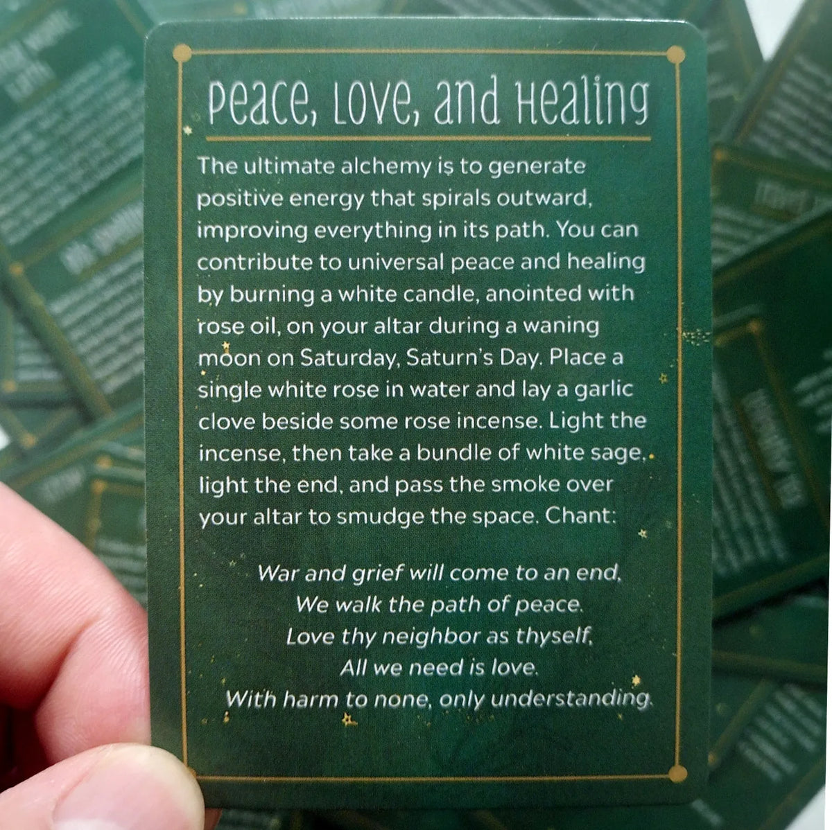 A green card with text about peace, love, and healing is shown against a dark background.