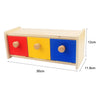 Wooden sensory toy set with three colored drawers in red, yellow, and blue for toddlers
