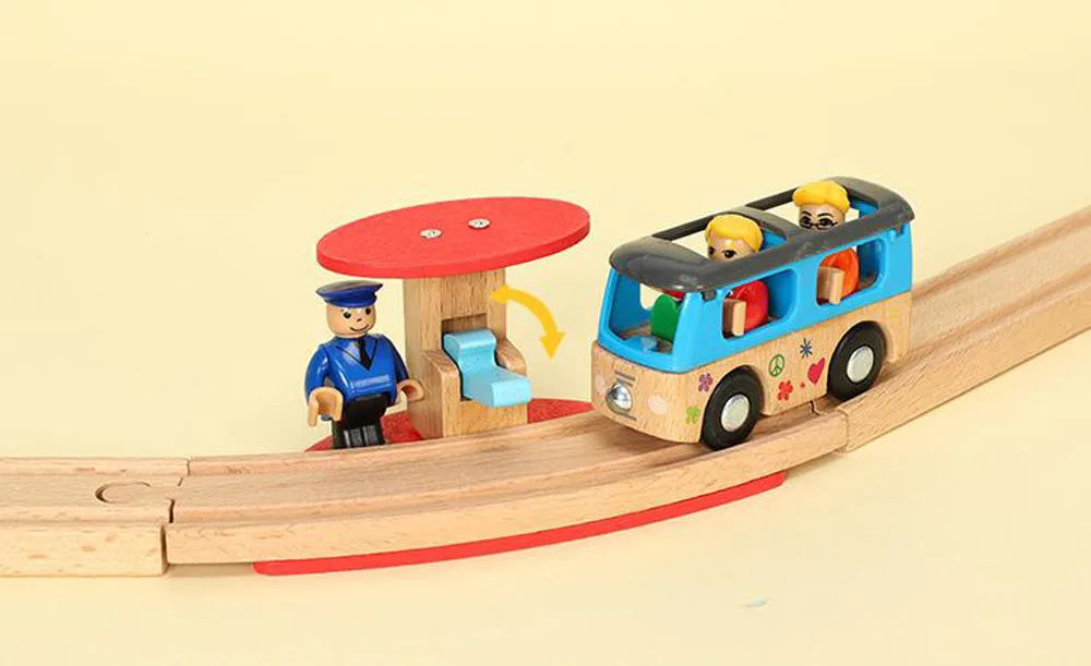 A wooden train track set featuring airport and gas station scenes with minifigure passengers.