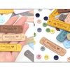 A hand holds a collection of 20 leather-style handmade with love tags in various colors and shapes for crafts.