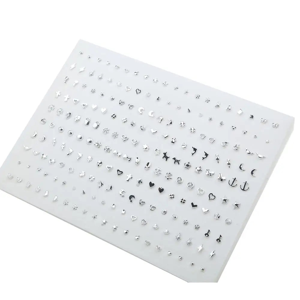 A flat display of assorted acrylic stud earrings featuring hearts, stars, moons, and other designs.