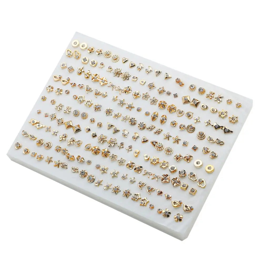 A collection of assorted acrylic stud earrings featuring hearts, stars, and moons in gold-toned metal.