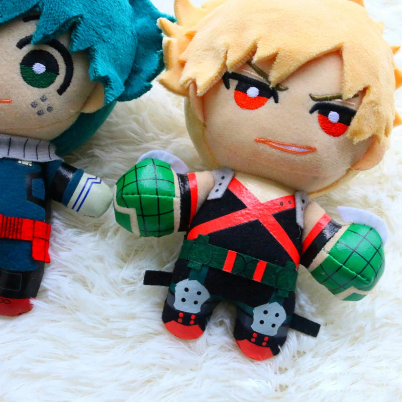 Two My Hero Academia plush figures, one with teal hair and another with blonde hair, are displayed on a white fluffy surface.