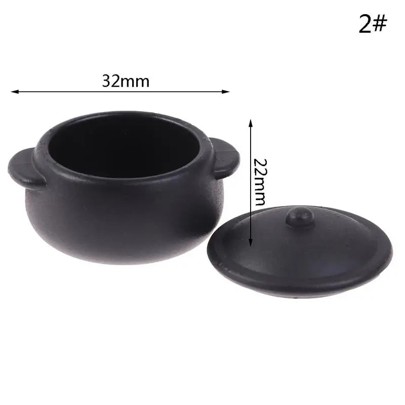 Black miniature copper soup pot with a lid and measurement markings