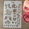 A clear silicone stencil sheet with various floral and decorative elements like bows, roses, hearts, and vines for crafting.