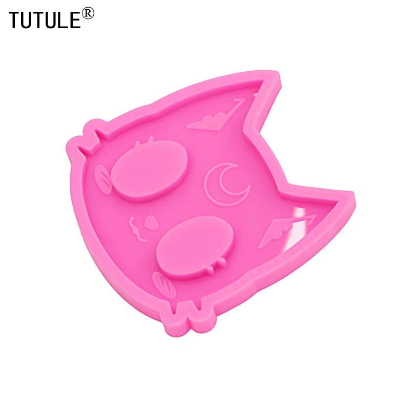 Pink silicone mold shaped like a cat head for DIY keychains and craft projects