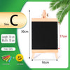 Mini wooden chalkboard easel with a black board, chalks, and an eraser, displayed on a white background.