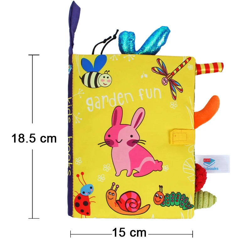 A yellow cloth book featuring various soft animal tails and sensory elements for baby development.