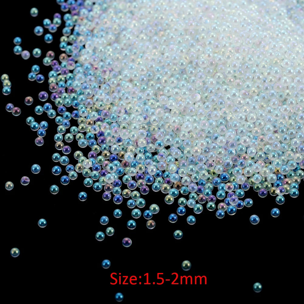 A pile of small, iridescent glass bubble beads in various shades of blue and purple.