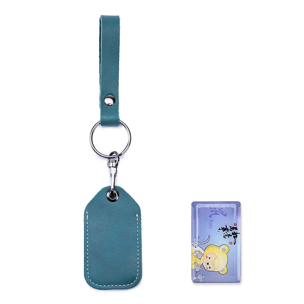 A teal leather key wallet with a silver keyring and card holder attached.