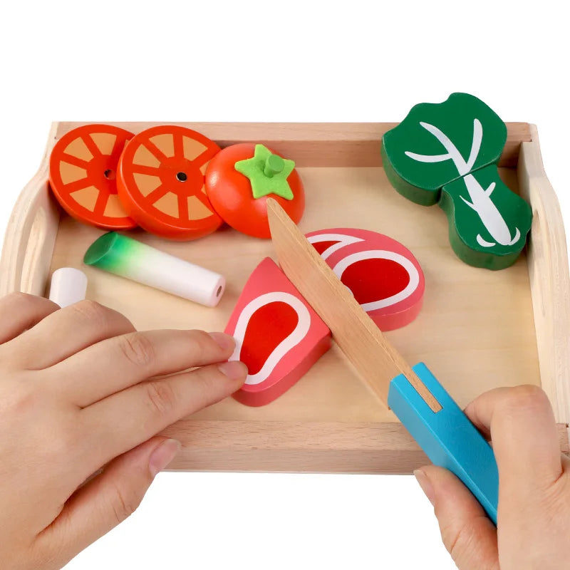 A wooden magnetic fruit and vegetable cutting play set with various colored fruits and vegetables being cut by a wooden knife