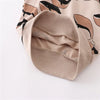 A beige long sleeve pullover sweatshirt with a black whale print visible inside the sleeve cuff.