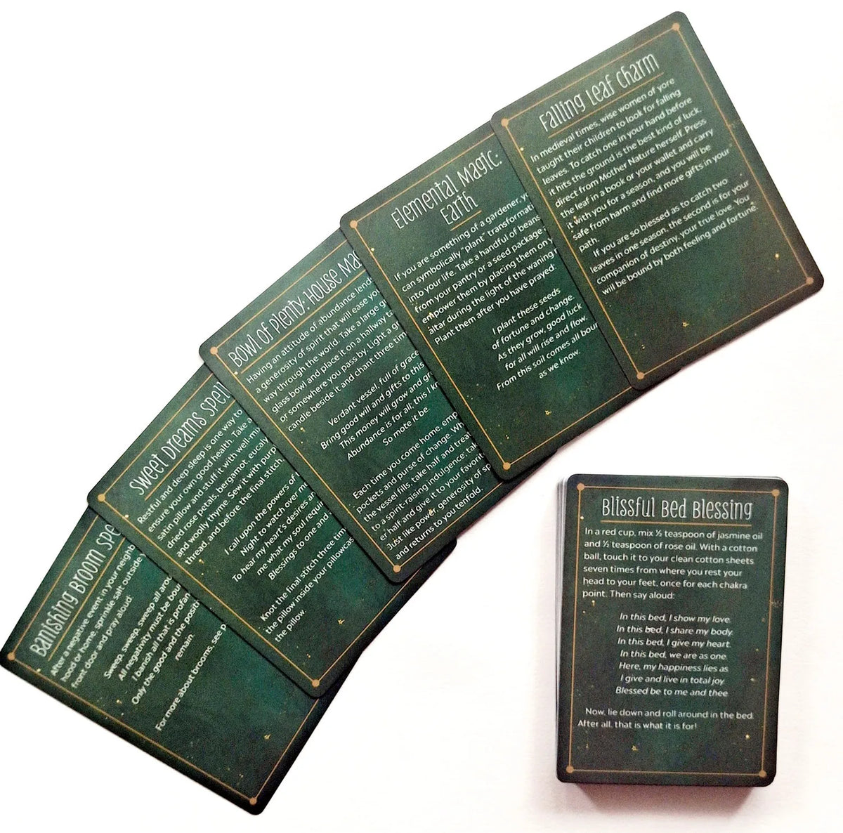 A spread of five themed cards from a witch's spell tarot deck featuring dark green and gold artwork