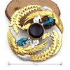 A gold-colored metal fidget spinner featuring a rainbow finish and a black center, resting on a wooden surface.