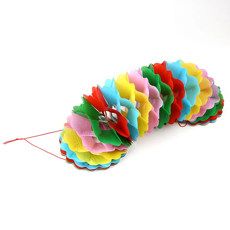 A colorful, layered bag or prop with multiple vibrant colors like red, orange, yellow, green, and blue.
