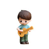 A figurine of a boy with brown hair wearing a blue shirt holding a yellow ukulele.