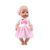 A baby doll with pink skin and a pink dress featuring a flamingo design.