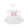 A white handmade doll dress for an 18-inch American Girl doll featuring a cat face design and a bow.