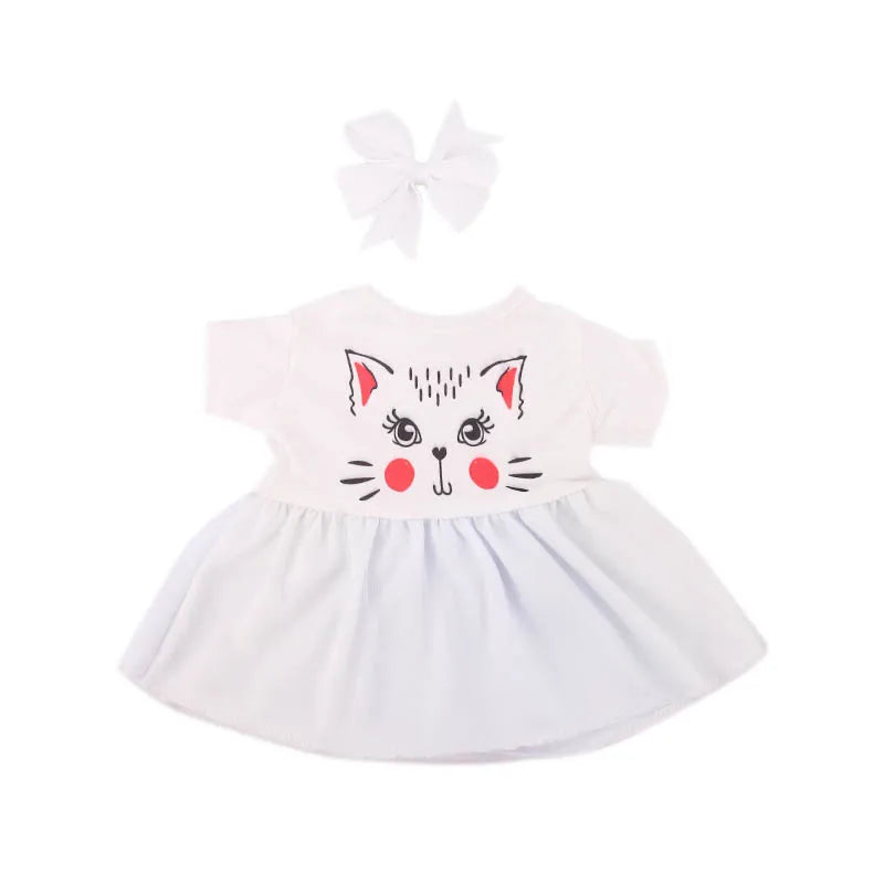 A white handmade doll dress for an 18-inch American Girl doll featuring a cat face design and a bow.