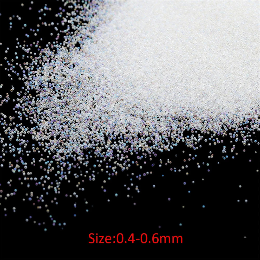 A pile of fine, white and iridescent glass bubble beads with a size range of 0.4 to 0.6 mm.