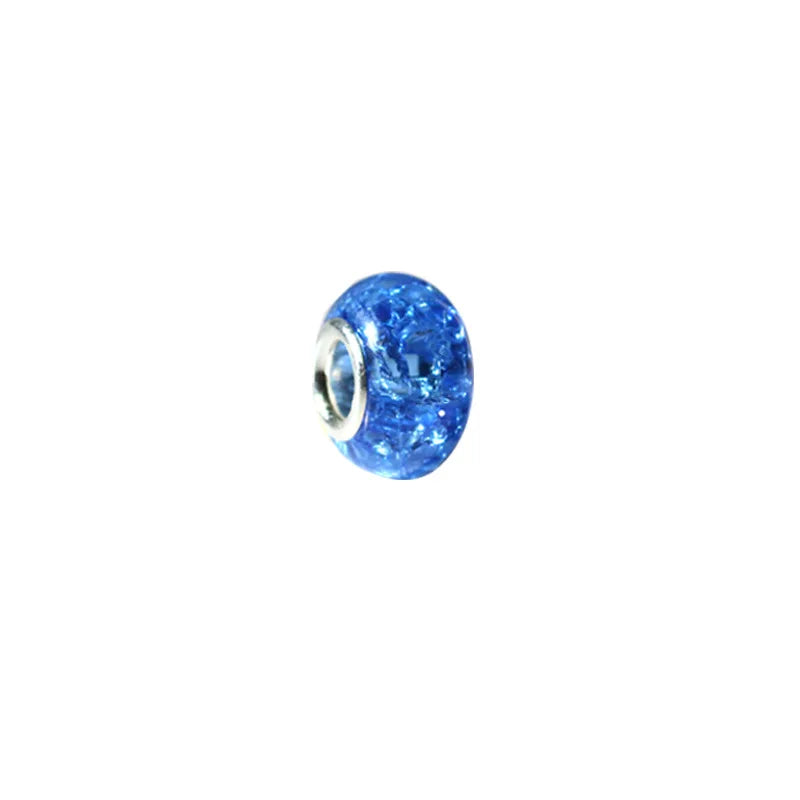 A close-up view of a bright blue, glittery resin spacer bead.