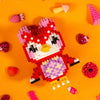 A red and pink building block set featuring an animal character with white and yellow accents on an orange background.