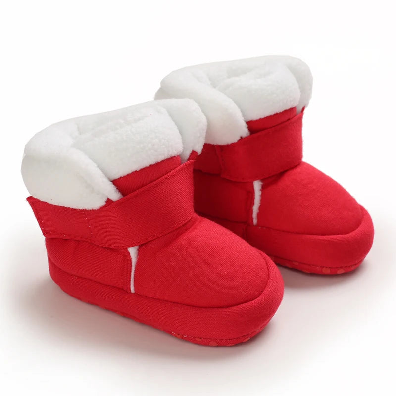 Pair of red baby first walker shoes with white faux fur trim