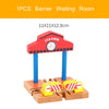 A wooden train track accessory set featuring an airport and gas station scene with a station sign and fuel pump.