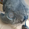 A close-up of a soft blue Eeyore plush toy with light gray fur and a circular Disney tag on its back.