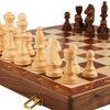 A handcrafted wooden folding chess set featuring solid walnut pieces arranged on a chessboard.