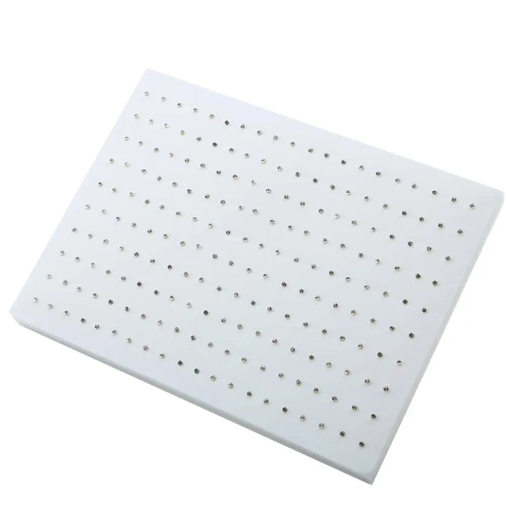 A white acrylic stud earring set featuring assorted shapes like hearts, stars, and moons.