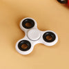 A white and black ABS tri-spinner fidget toy for focus and stress relief