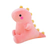 A pink cute dinosaur plush toy with yellow spikes and a small pink nose.