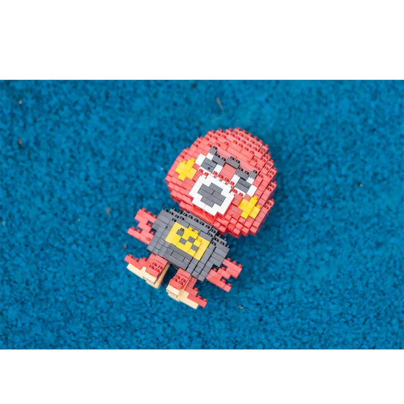 A small model of a red and gray animal built from interlocking plastic bricks on a blue surface.