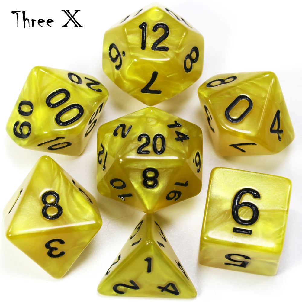 A collection of yellow marble effect polyhedral dice including a d10, d6, and d8.
