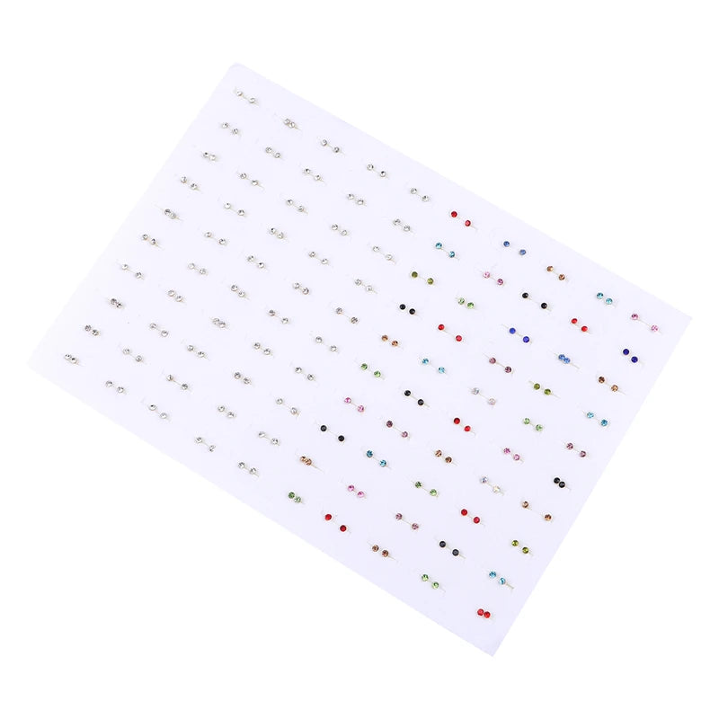 A sheet of assorted acrylic stud earrings featuring hearts, stars, and moons in various colors.